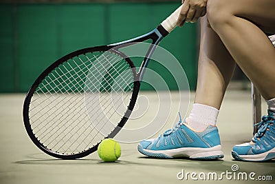 Lady tennis player sitting in the court during game break Stock Photo