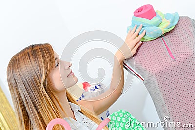 Lady touching scarf on mannequin Stock Photo