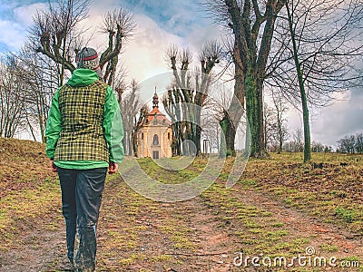 Lady in treking clothes walk in fall tree avenue Stock Photo