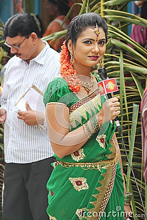 Lady TV anchor covering a public event in India Editorial Stock Photo