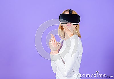 Lady with weapon gesture. Enthralling interaction virtual reality. Woman head mounted display violet background. Virtual Stock Photo