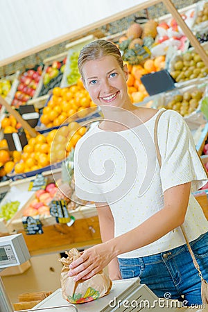 Lady weighing produce in paper bag Stock Photo