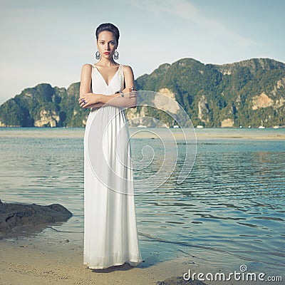 Lady in white dress on a seashore Stock Photo