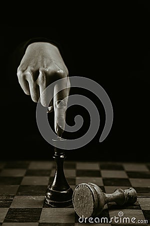 Lady wins round with an opponent. Woman player playing board intelligence game - old wooden chess. Victory over enemy Stock Photo