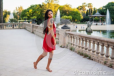 Ladyboy tattooed transgender model is dancing in the green park Stock Photo