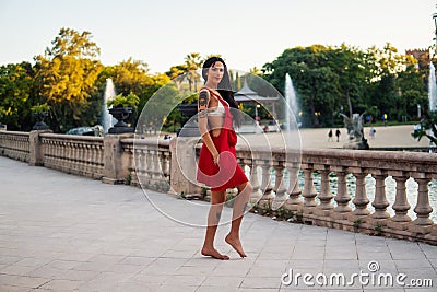 Ladyboy tattooed transgender model is dancing in the green park Stock Photo