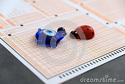 Ladybug,evil eye bead and optical exam paper, exam and luck Stock Photo