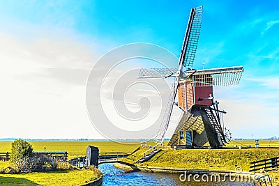 Lagenwaardse historic smock mill in Dutch polder landscape Stock Photo