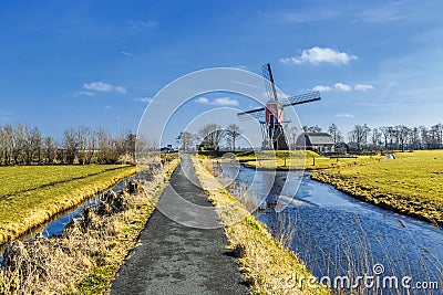 Lagenwaardse historic smock mill in Dutch polder landscape Stock Photo