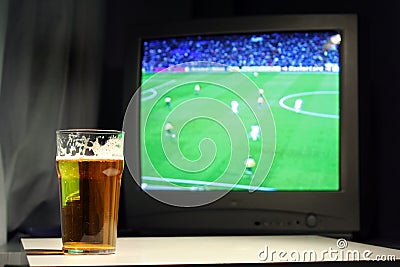 Lager and football on the tv Stock Photo