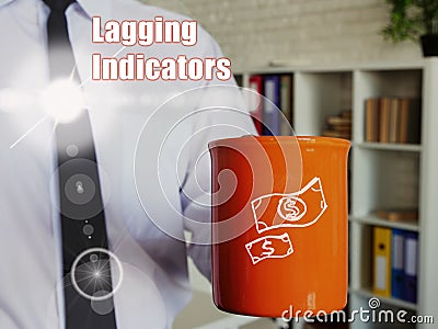 Lagging Indicators phrase. Man with a cup of coffee in the background Stock Photo