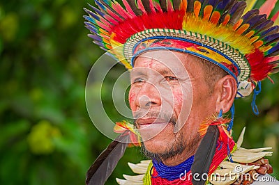 LAGO AGRIO, ECUADOR - NOVEMBER 17, 2016: Portrait of a Siona shaman in traditional dress with a feather hat in an Editorial Stock Photo