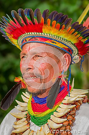 LAGO AGRIO, ECUADOR - NOVEMBER 17, 2016: Portrait of a Siona shaman in traditional dress with a feather hat in an Editorial Stock Photo