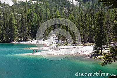 Lago Di Braies, Italy - June 1, 2018: View on the crystal clear lake with people on beach Editorial Stock Photo
