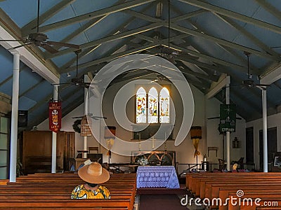 LAHAINA, UNITED STATES OF AMERICA - JANUARY 7, 2015: worshiper sits in a pew in the interior of the holy innocents church in Editorial Stock Photo