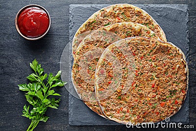 Lahmacun traditional turkish pizza with minced beef or lamb meat, paprika, tomatoes, cumin spice Stock Photo