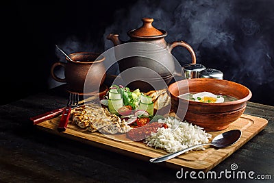 Laid dinner on the table, onion and egg soup, rice, chicken breast. Stock Photo