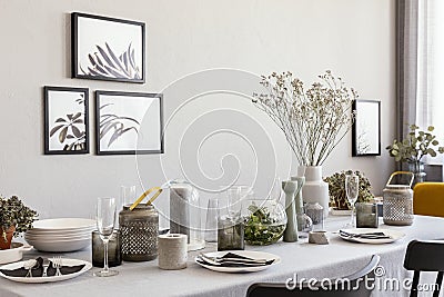 Laid table with champagne glasses and flowers in a modern dining room interior Stock Photo