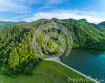 Lake bay with highway on shore and high Rhodope Mountains surrounded Stock Photo