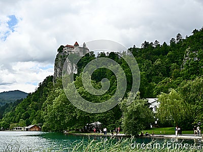 Lake Bled, Slovenia, Shoreline With Bled Castle on Top of Cliff Editorial Stock Photo