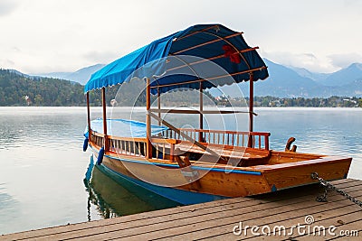 Lake Bled and traditional wooden Pletna at autumn Stock Photo