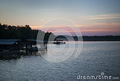 Lake and boat dock at sunrise Stock Photo