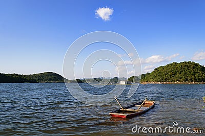 Lake boat with single cloud Stock Photo