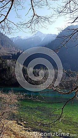 Lake with clear crisp water surrounded with Mountaineous Scenery Stock Photo