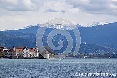 Lake Constance in the Lindau region against the backdrop of the snow-capped Alps. View of the island, the Powder Tower and Editorial Stock Photo