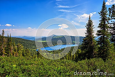 Lake in dark coniferous taiga. Nature Park Ergaki. Stock Photo