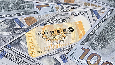 Lake Elsinore, CA, USA - September 30, 2023: Focus on Powerball lottery tickets surrounded by US currency. Editorial Stock Photo
