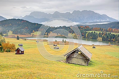 Lake Geroldsee in colorful autumn season, a beautiful alpine lake between Garmisch-Partenkirchen and Mittenwald with foggy Stock Photo