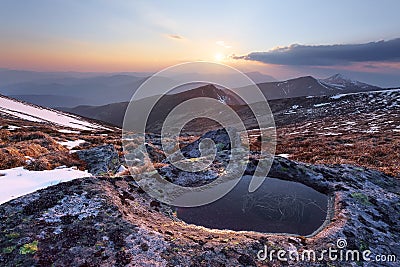 Lake at the high mountains. Sun rays enlighten the valley. Majestic spring scenery. Location place the Carpathian, Ukraine, Europe Stock Photo