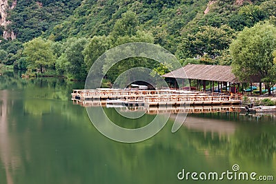 Lake house with pier and woods Stock Photo