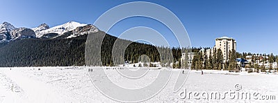 Lake Louise, CANADA - MARCH 20, 2019: frozen lake and mountains with snow peaks Editorial Stock Photo