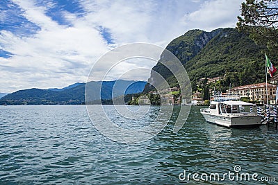 Lake Lugano, Switzerland - a boat on shiny waters. Editorial Stock Photo