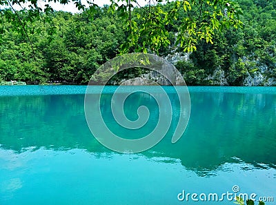 The lake with luminous azure-colored water. Greenery and rocks. Plitvice Lakes, Croatia Stock Photo