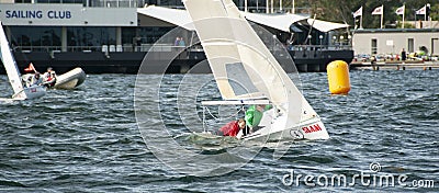 Girl overboard from racing dinghy. April 16, 2013: Editorial Editorial Stock Photo