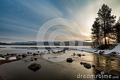 Early morning sunrise in winter over an Idaho mountain lake near Stock Photo