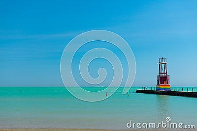 Lake Michigan and a Light Beacon painted with the Rainbow Gay Pride Flag at Kathy Osterman Beach in Edgewater Chicago Editorial Stock Photo
