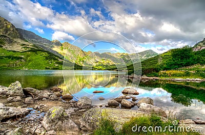 Lake in mountains in the early morning colors. Stock Photo