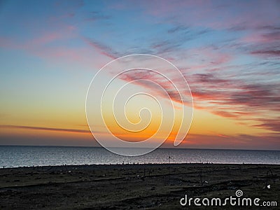 A lake with red cloud in sky at sunrise Stock Photo