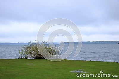 The Lake Schwerin (German: Schweriner See) at the castle and the city on a cloudy day Stock Photo