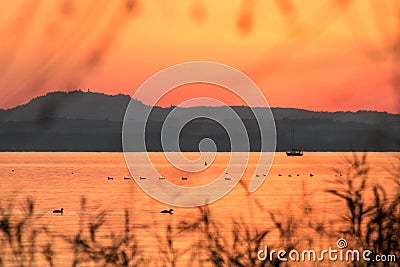 A lake at sunset, with warm orange tones in the whole image, boa Stock Photo