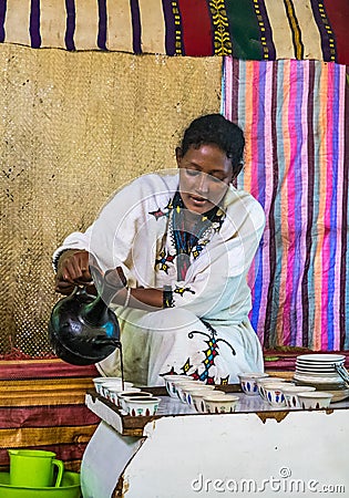 Lake Tana, Ethiopia - Feb 05, 2020: Zege Peninsula in Lake Tana. Young woman is preparing a coffee ceremony Editorial Stock Photo