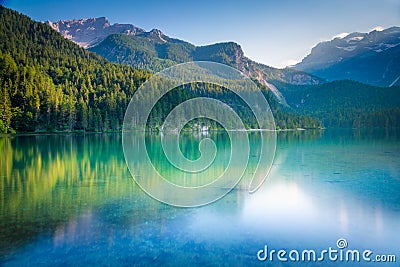 Lake Tovel reflection symmetry in Trentino-Alto Adige, Dolomites, Italy Stock Photo