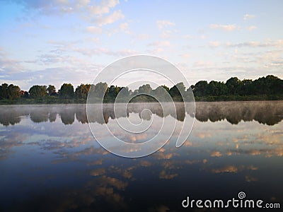 Lake with trees. Summer landscape by the river.Glassy surface of the water Stock Photo