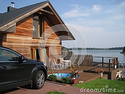 Lake view house with car and swimming pool Stock Photo