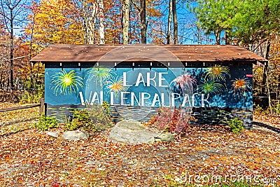 Lake Wallenpaupack clubhouse sign in Poconos PA on a bright fall day lined with trees Editorial Stock Photo