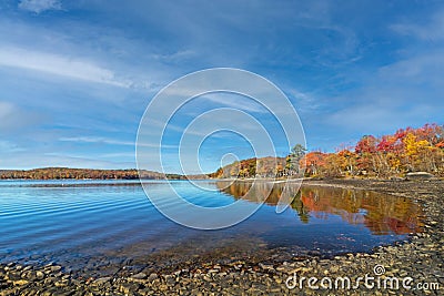 Lake Wallenpaupack in Poconos PA on a bright fall day lined with trees Stock Photo